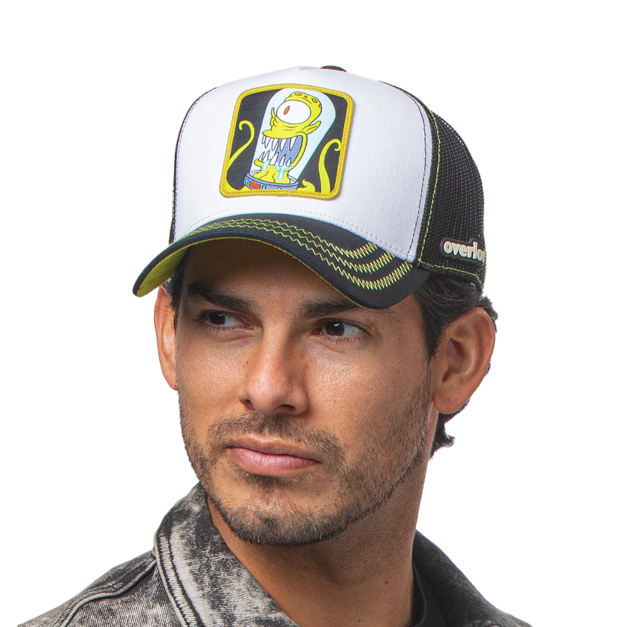 Man wearing white and black OVERLORD X The Simpsons present Kang the alien trucker baseball cap hat with lime green zig zag stitching. PVC Overlord logo.