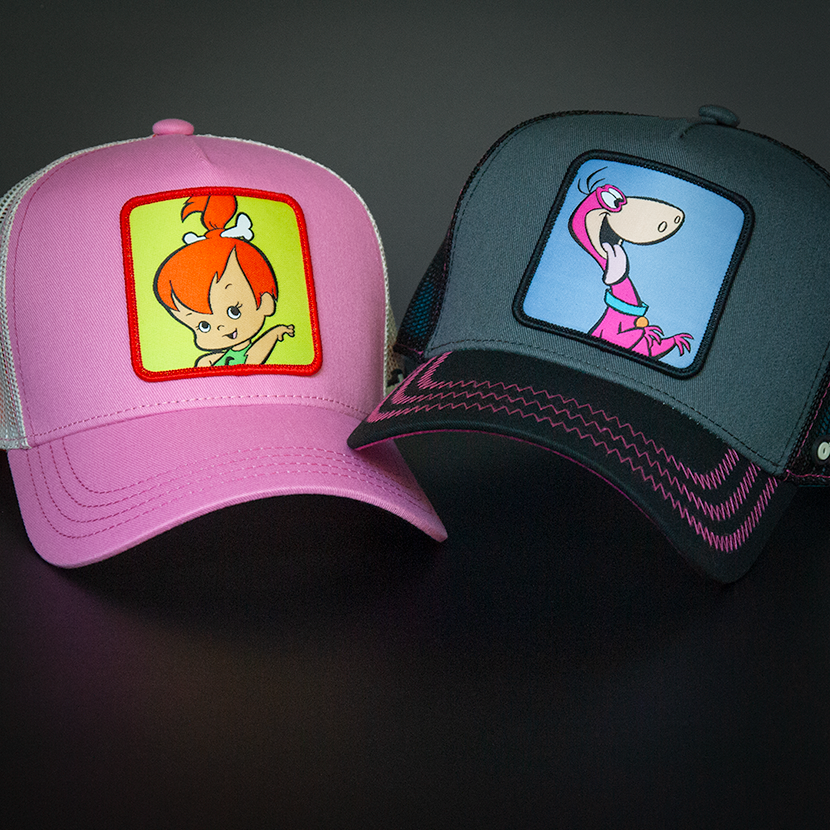 Pink OVERLORD X Flintstones Pebbles trucker baseball cap with dark pink stitching. PVC Overlord logo.