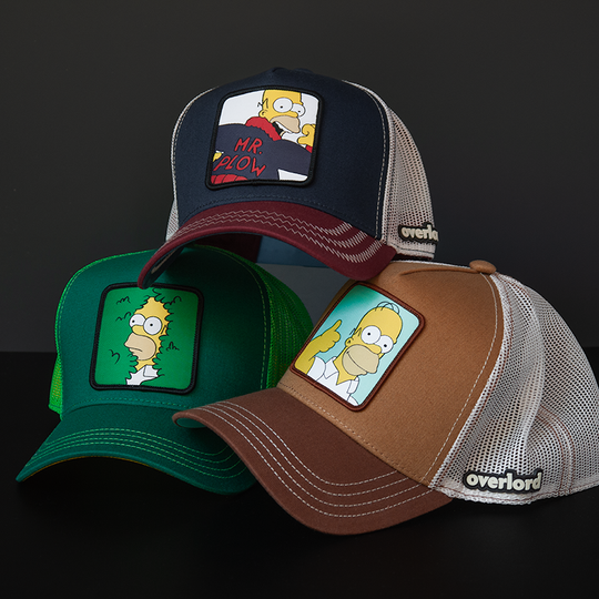 Brown OVERLORD X The Simpsons Homer doing thumbs up trucker baseball cap hat with khaki stitching. PVC Overlord logo.