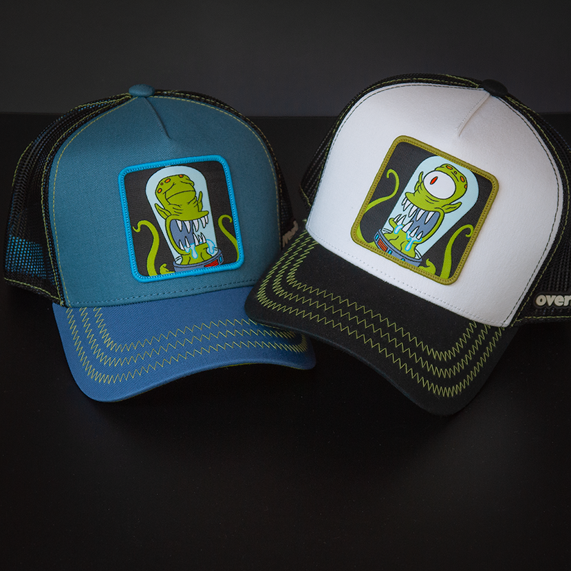 White and black OVERLORD X The Simpsons present Kang the alien trucker baseball cap hat with lime green zig zag stitching. PVC Overlord logo.