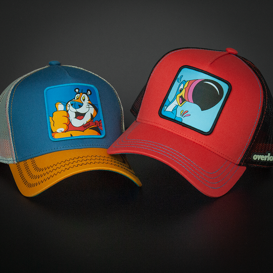 Red OVERLORD X Kelloggs Toucan Sam Froot Loops trucker baseball cap hat with blue stitching. PVC Overlord logo.