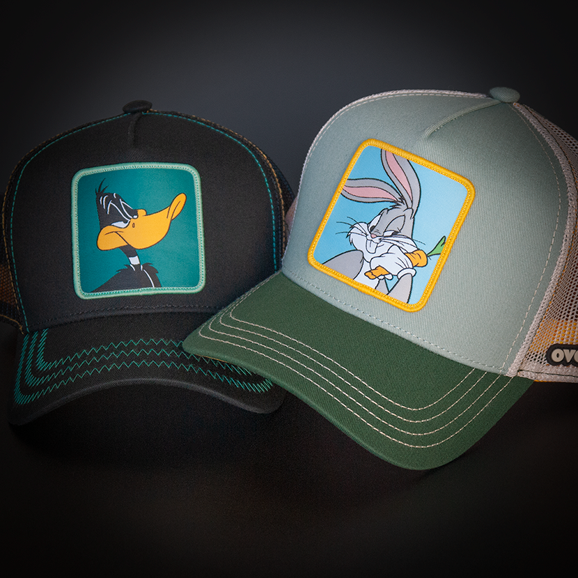 Gray green OVERLORD X Looney Tunes Bugs Bunny trucker baseball cap hat with cream stitching. PVC Overlord logo.