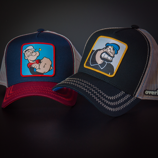 Black OVERLORD X Popeye angry Brutus Bluto trucker baseball cap hat with khaki zig zag stitching. PVC Overlord logo.