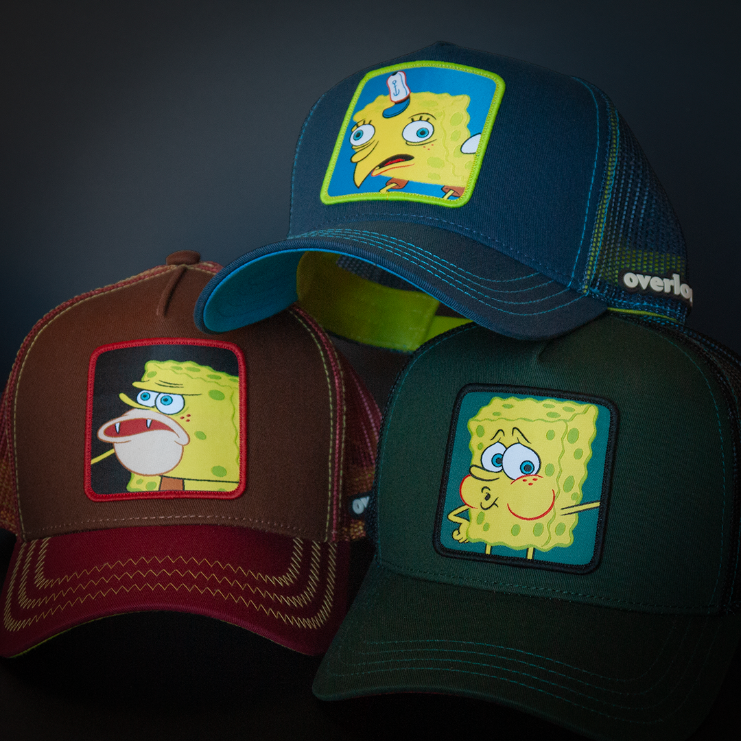 Brown and maroon OVERLORD X SpongeBob Caveman SpongeBob meme trucker baseball cap hat with yellow zig zag stitching. PVC Overlord logo.