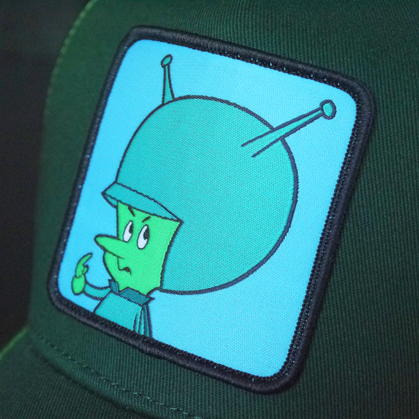 Forest green OVERLORD X Flintstones Great Gazoo trucker baseball cap hat woven Overlord patch closeup.