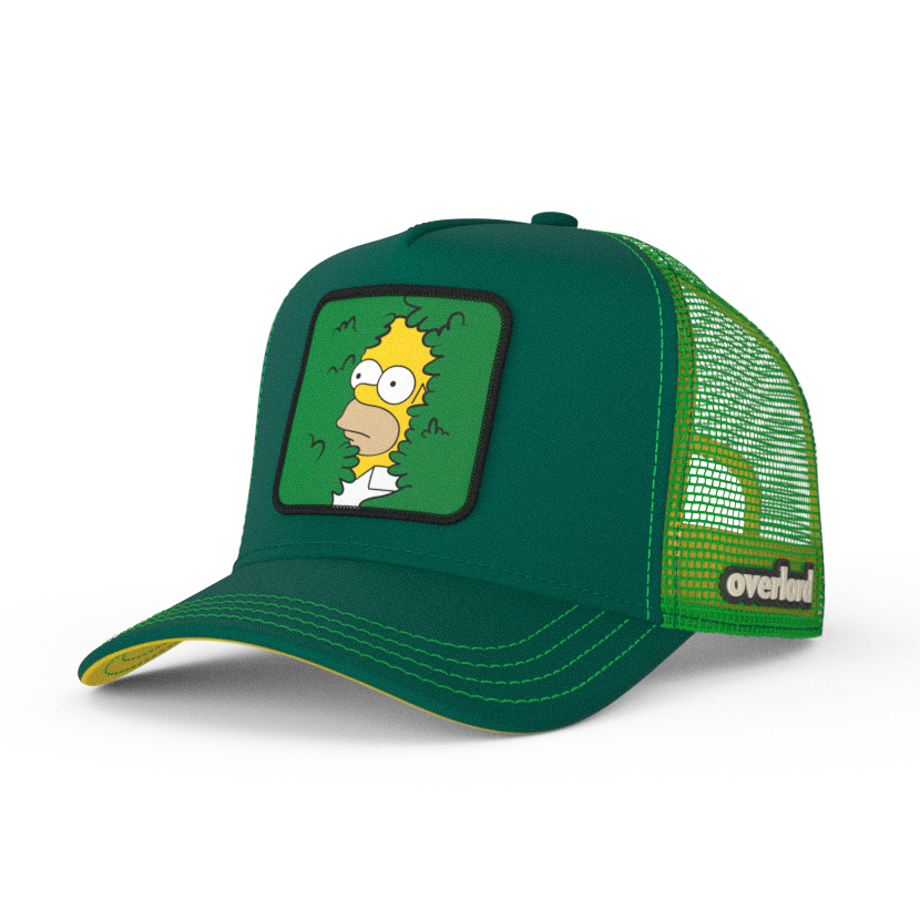 Green OVERLORD X The Simpsons present Homer in bush trucker baseball cap hat with green stitching. PVC Overlord logo.