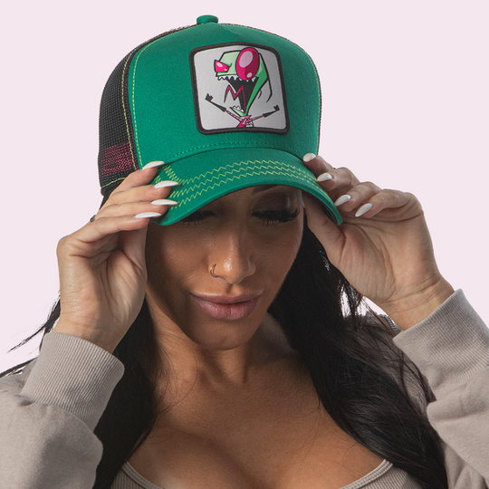 Woman wearing green OVERLORD X Invader Zim screaming Zim trucker baseball cap hat with light green zig zag stitching. PVC Overlord logo.