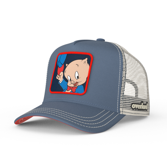 Blue OVERLORD X Looney Tunes Porky Pig holding a hat trucker baseball cap hat with cream stitching. PVC Overlord logo.