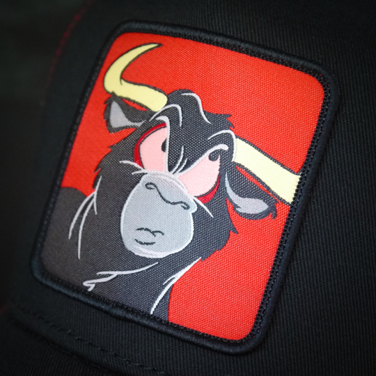 Black OVERLORD X Looney Tunes Toro the bull trucker baseball cap hat woven Overlord patch closeup.