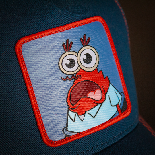 Navy OVERLORD X SpongeBob Krusty Krab surprised face trucker baseball cap woven Overlord patch closeup.