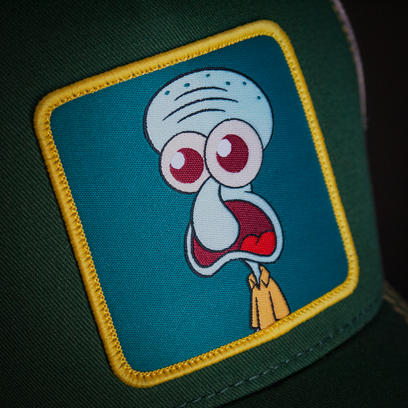 Dark green OVERLORD X SpongeBob Squidward surprised face trucker baseball cap woven Overlord patch closeup.