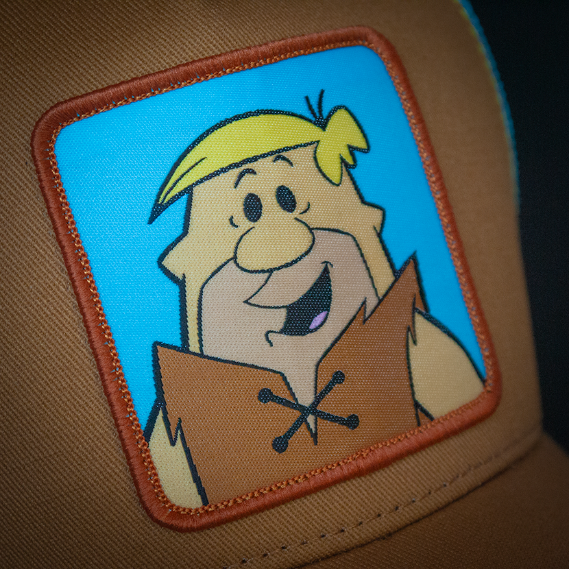 Brown OVERLORD X Flintstones Barney Rubble trucker baseball cap woven Overlord patch closeup.