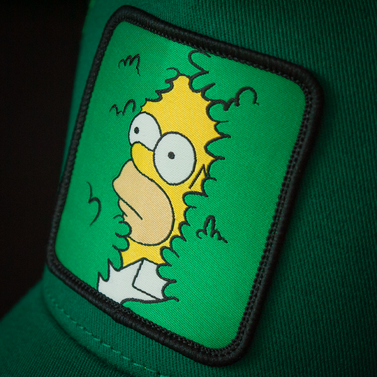 Green OVERLORD X The Simpsons present Homer in bush trucker baseball cap hat woven Overlord patch closeup.