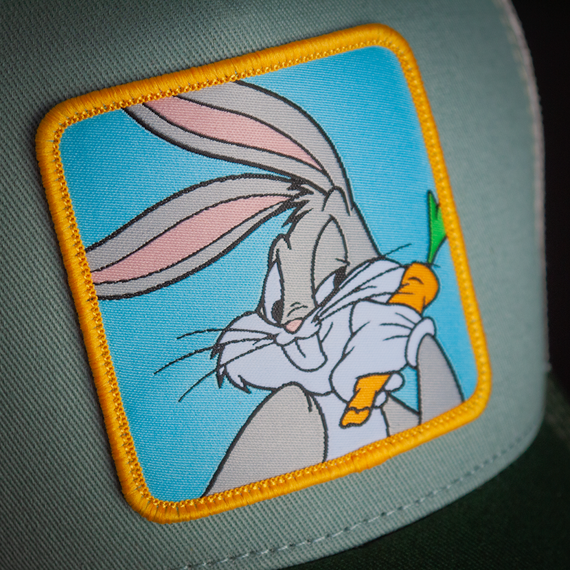 Gray green OVERLORD X Looney Tunes smug Bugs Bunny trucker baseball cap hat woven Overlord patch closeup.