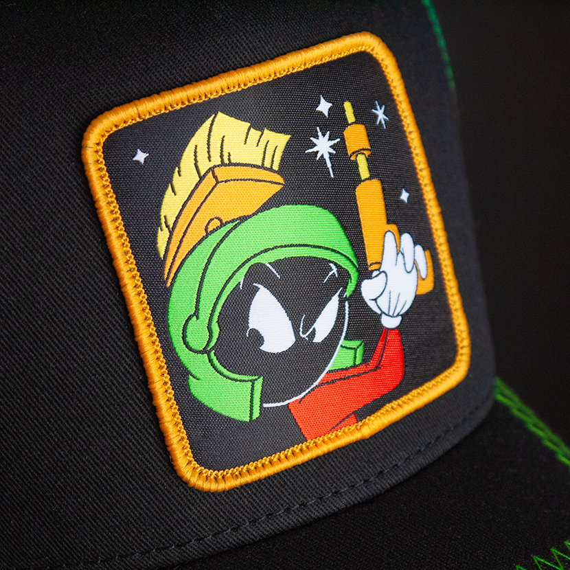Black OVERLORD X Looney Tunes Marvin the Martian holding a gun trucker baseball cap hat woven Overlord patch closeup.