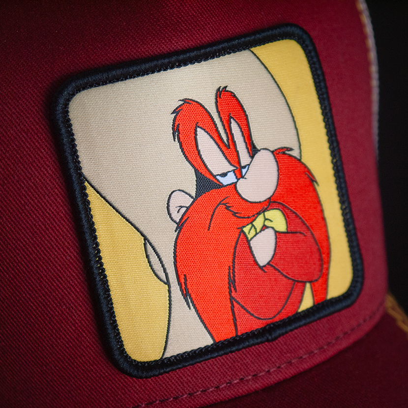 Dark Red OVERLORD X Looney Tunes smug Yosemite Sam trucker baseball cap hat woven Overlord patch closeup.