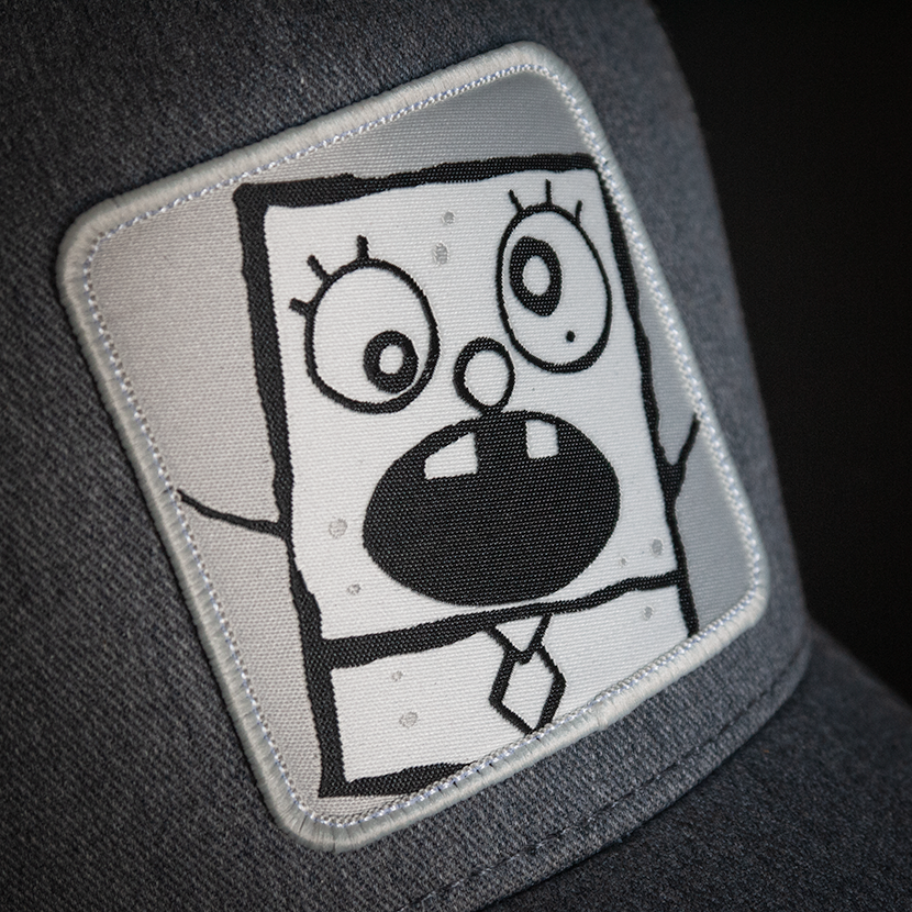 Heather Gray OVERLORD X SpongeBob DoodleBob trucker baseball cap hat woven Overlord patch closeup.