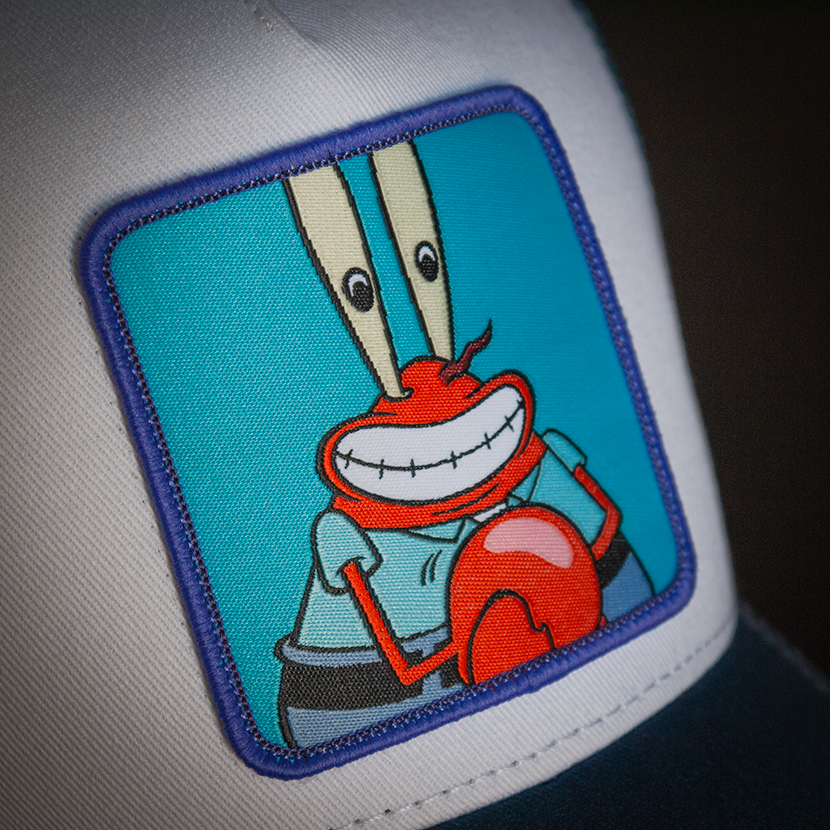 White OVERLORD X SpongeBob Krusty Krab trucker baseball cap hat woven Overlord patch closeup.