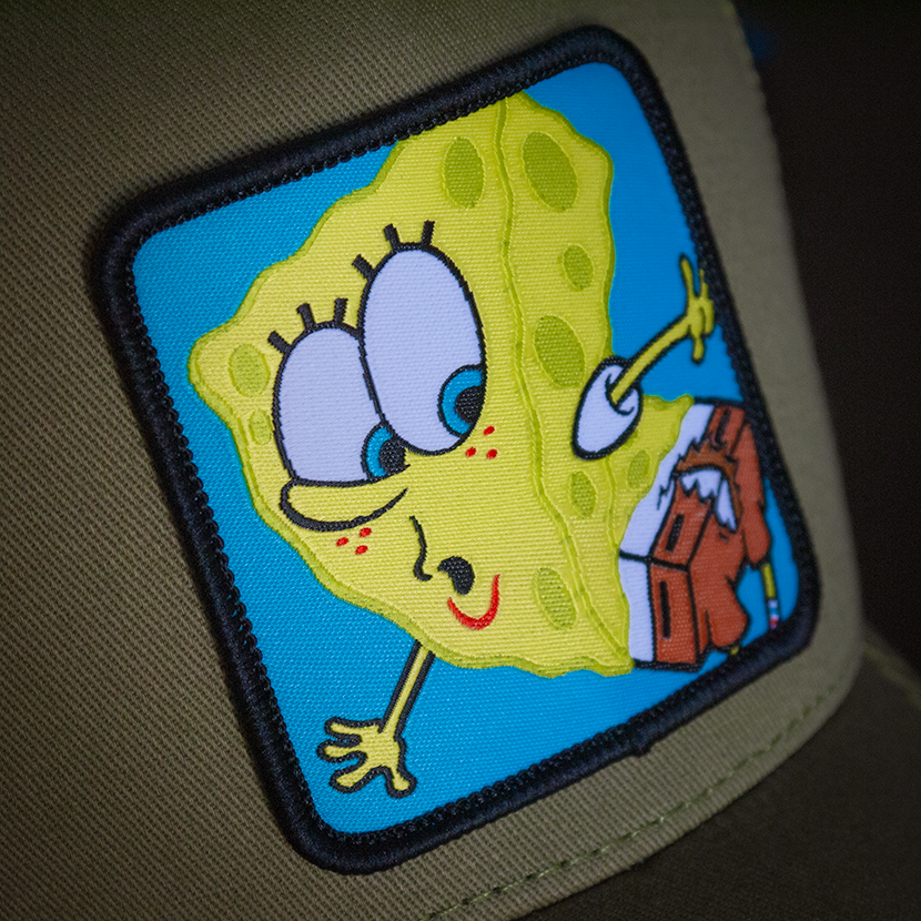 Olive green OVERLORD X SpongeBob with ripped pants trucker baseball cap hat woven Overlord patch closeup.