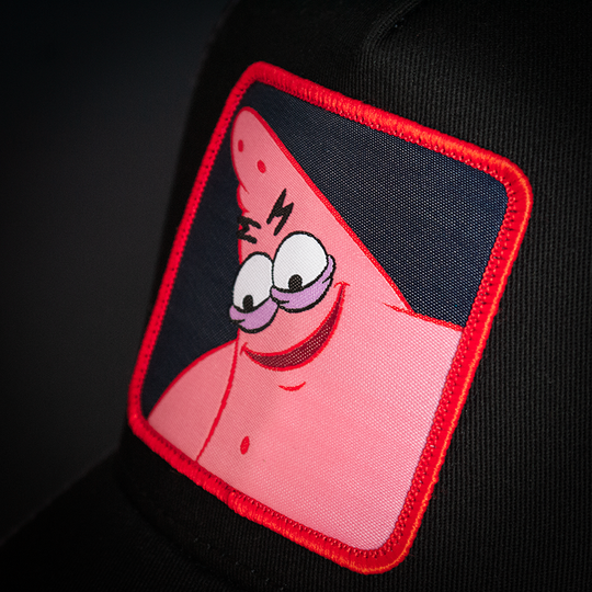 Black OVERLORD X SpongeBob Savage Patrick trucker baseball cap hat woven Overlord patch closeup.