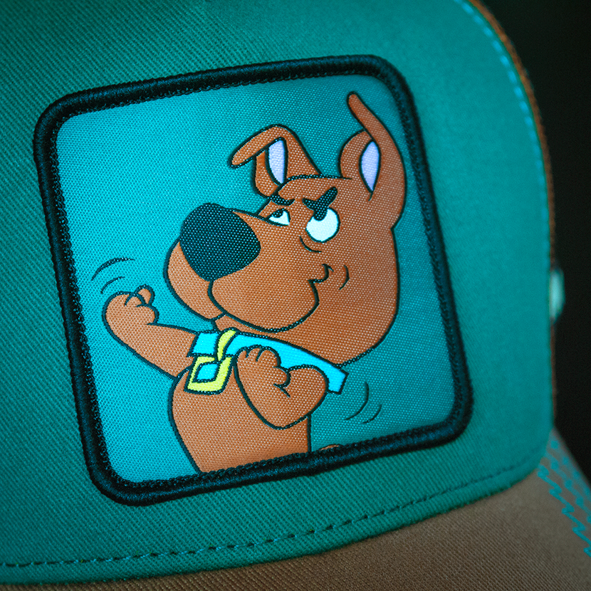 Teal and light brown Scooby-Doo fighting Scrappy trucker baseball cap hat woven Overlord patch closeup.