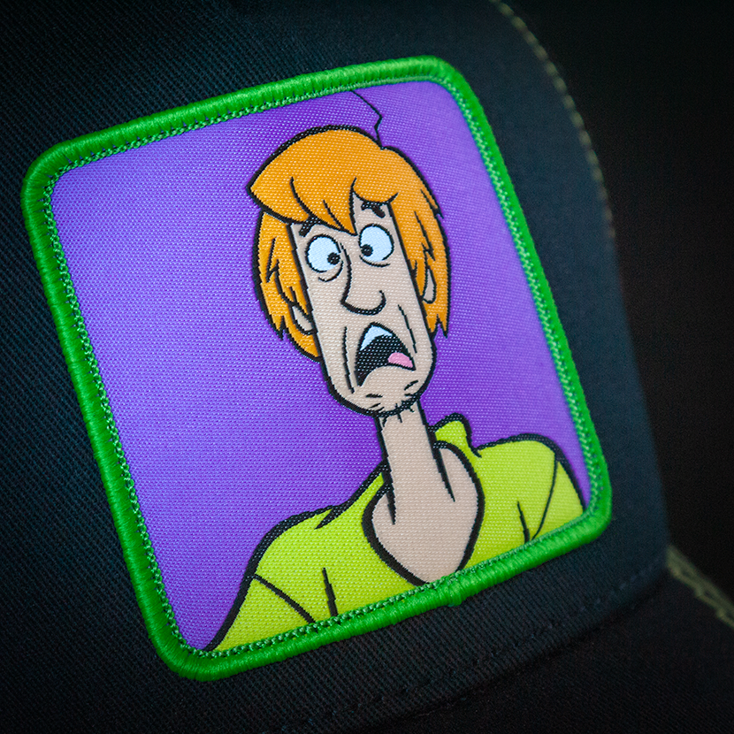 Black OVERLORD X Scooby-Doo scared Shaggy trucker baseball cap hat woven Overlord patch closeup.