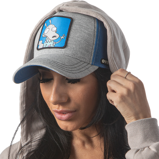 Woman wearing heather gray jersey OVERLORD X Rocko's Modern Life Rocko trucker baseball cap hat with black stitching. PVC Overlord logo.