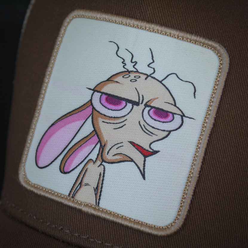 Brown OVERLORD X Ren and Stimpy Ren trucker baseball cap hat woven Overlord patch closeup.