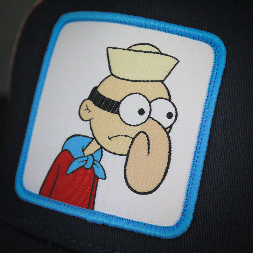 Navy OVERLORD X SpongeBob Barnacle Boy trucker baseball cap hat woven Overlord patch closeup.