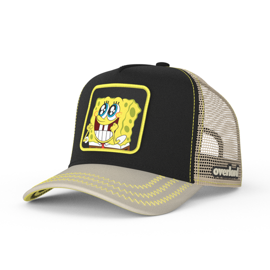 Black and tan OVERLORD X SpongeBob Big Smile SpongeBob trucker baseball cap hat with yellow zig zag stitching. PVC Overlord logo.