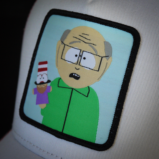 White OVERLORD X South Park Mr. Garrison trucker baseball cap hat woven Overlord patch closeup.