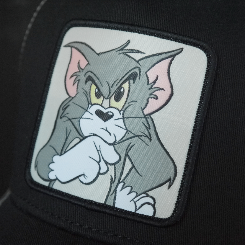 Black OVERLORD X Tom and Jerry Tom cat trucker baseball cap hat woven Overlord patch closeup.