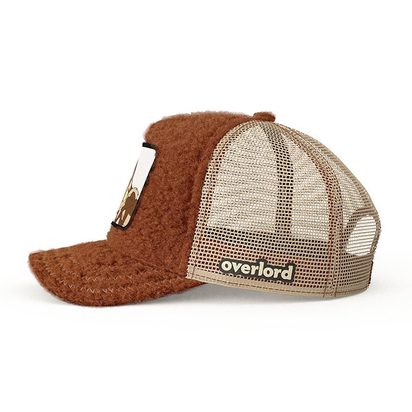 Brown sherpa OVERLORD X Looney Tunes Wile E. Coyote trucker baseball cap hat with khaki mesh. PVC Overlord logo.