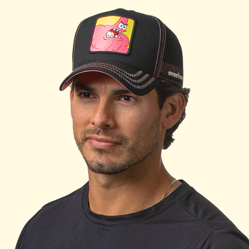 Man wearing black OVERLORD X SpongeBob Wrestling Patrick trucker baseball cap hat with pink zig zag stitching. PVC Overlord logo.